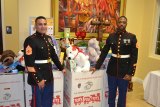 U.S. Marines Gunnery Sergeant Nicholas Lopez and Staff Sergeant Anthony Carrington dutifully guard the stash of Christmas presents collected Saturday night for Toys for Tots.